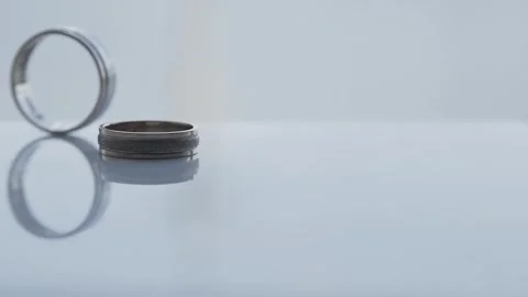 Wedding rings rolling on the table in motion Stock-Footage 306148561