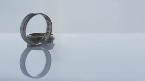 Wedding rings rolling on table in motion, wedding day Stock Footage 306148569