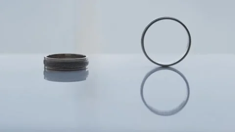 Wedding rings rolling on table in slow motion, wedding day 스톡 동영상 306148591