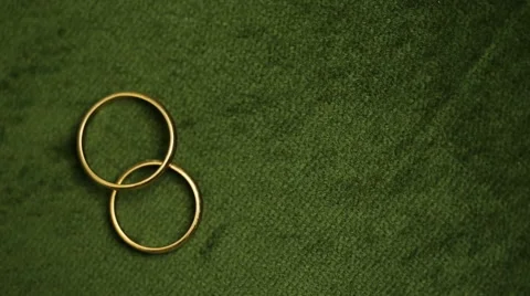 Wedding rings rotating with textured background Stock Footage 68628413