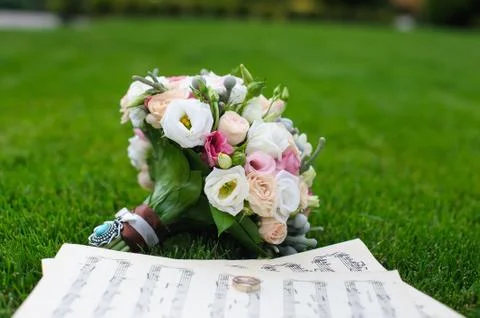 Wedding rings on a sheet of paper with notes Stock Photos