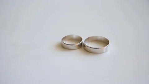 Wedding rings shine in the sun Stock Footage 70382266