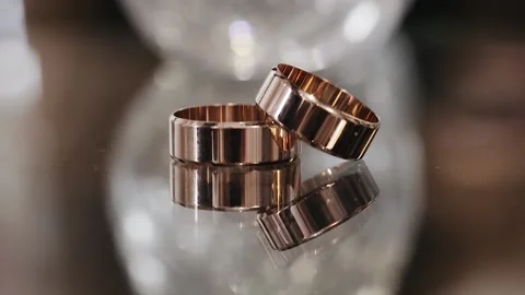 Wedding rings with sparkles on them and on the background of crystal glass Stock Footage 234917254
