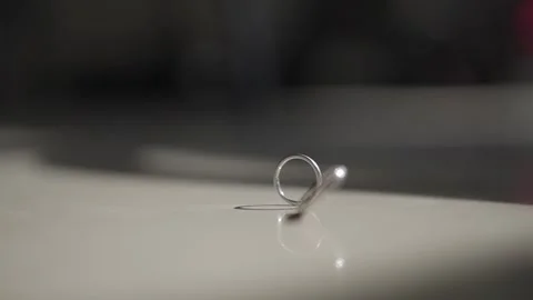 Wedding rings spinning on table in slow motion. Stock Footage 323805115