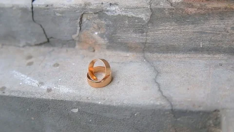 Wedding rings stand on a concrete surface Stock Footage 123836500