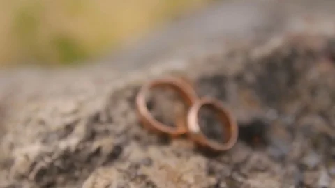 Wedding rings on a stone Stock Footage 70946160