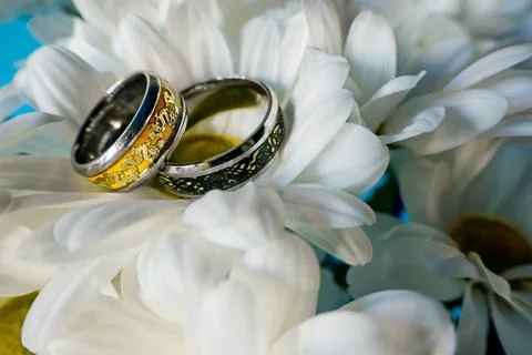 Wedding rings surrounded by various wedding details. Stock Photos