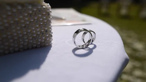 Wedding rings on a table among wedding decorations Stock Footage 114304180