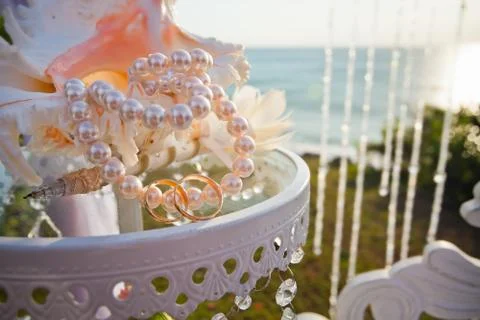 Wedding rings at table with beautiful shell Stock Photos