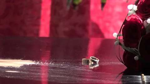 Wedding rings on a table in the sun Stock-Footage 62816821