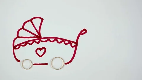 Wedding rings turn into the wheels of a pram. Family concept Video stock 84815760
