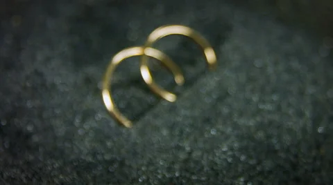 Wedding rings on volcanic sand. Elegant backdrop and close up rotation. Video stock 59792180