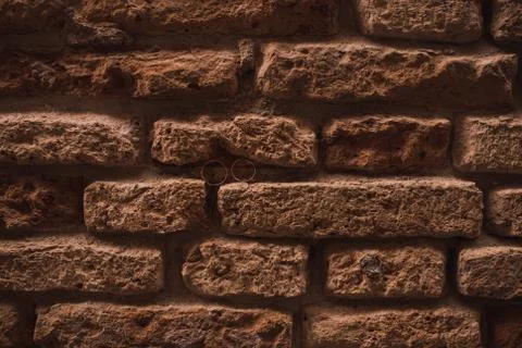 Wedding rings in the wall between bricks Stock Photos