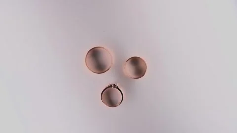 Wedding rings on a white background, camera movement Stock Footage 327982175