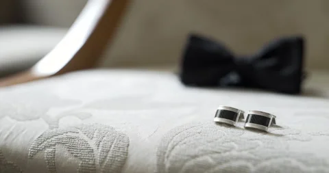 Wedding rings on a white bed with soft natural light Stockbeeldmateriaal 336470585