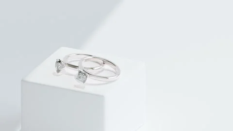 Wedding rings on white stand with shadows Stock Footage 252719871