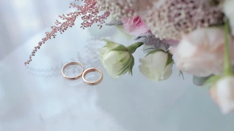 Wedding rings on a white table Stock Footage 88625236