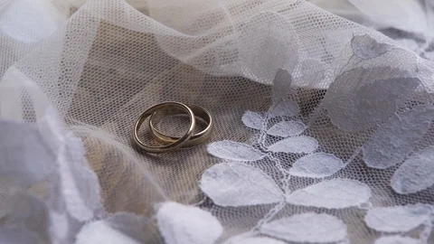 Wedding rings on a wooden table close up Stock Footage
