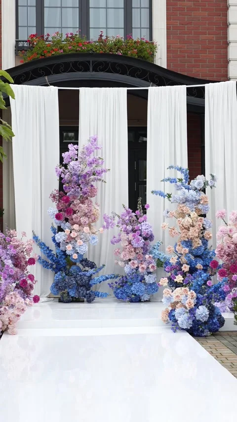 Wedding romantic flower arch on a white podium outdoors with fabric in blue pink Video stock 319045809