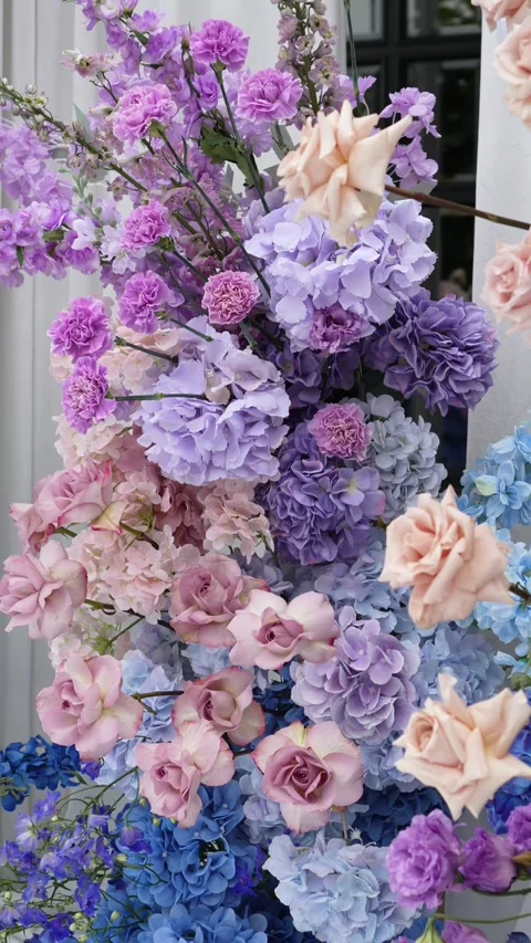 Wedding romantic flower arch on a white podium outdoors with fabric in blue pink Video stock 319045832
