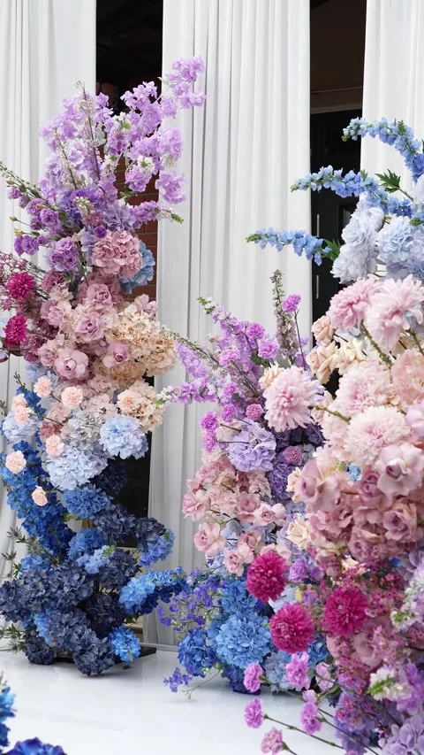 Wedding romantic flower arch on a white podium outdoors with fabric in blue pink Video stock 319045862
