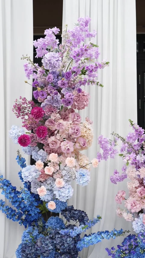 Wedding romantic flower arch on a white podium outdoors with fabric in blue pink Video stock 319045896