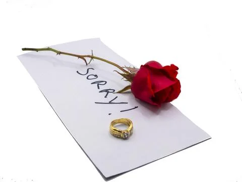 Wedding Rring and rose with note of apology Stock Photos