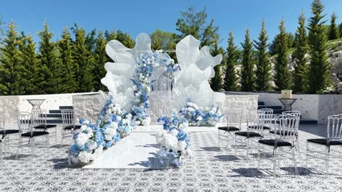 Wedding setup with blue and white floral decor on stone terrace Stock Footage 336218556