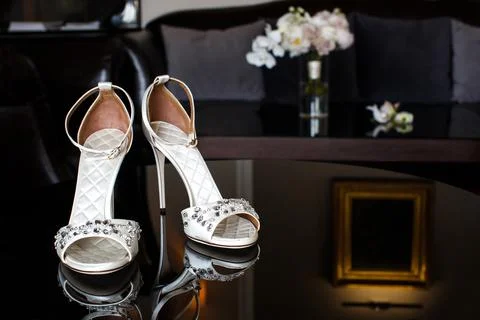 Wedding shoes with jewels on a mirror table Stock Photos
