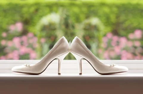 Wedding shoes by a window Stock Photos