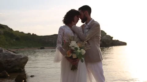 Wedding on the sunset with live floristry. Bride and groom in boho style. Stock Footage 185987146