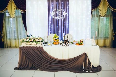 Wedding table for the bride and groom decorated with cloth and flowers Fotos Stock