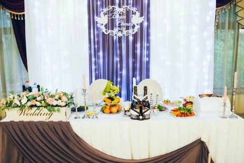 Wedding table for the bride and groom decorated with cloth and flowers 写真素材