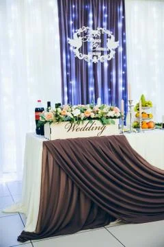 Wedding table for the bride and groom decorated with cloth and flowers 写真素材