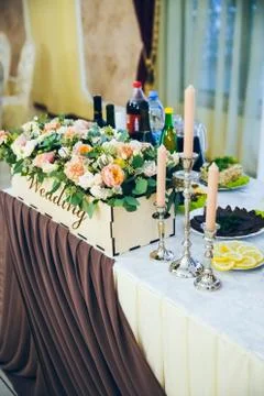Wedding table for the bride and groom decorated with cloth and flowers, close-up 写真素材