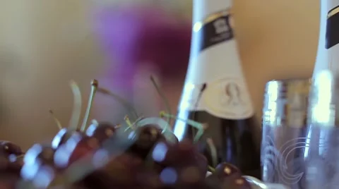 The wedding table. Champagne, cherries and white flowers. Video stock 68657139