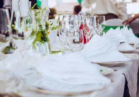 Wedding table. close-up of folded napkin and empty glasses Stock Photos