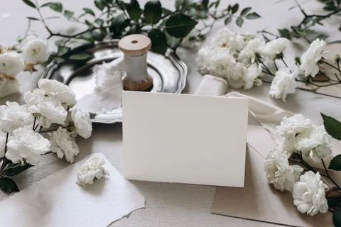 Wedding table composition. Place card mockup scene.with fading white rose 写真素材