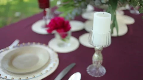 Wedding table decor at the nature with lighted candles, close-up. Steadicam shot Stock Footage 51342772