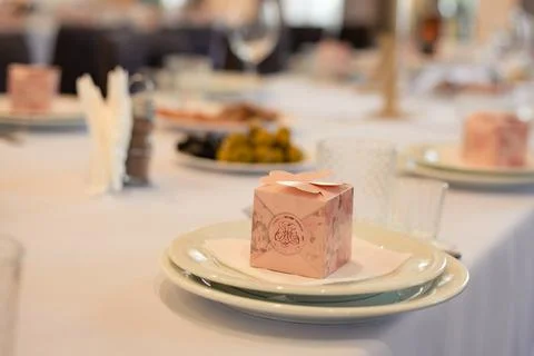 Wedding table decor, pink box on a white plate Stock Photos