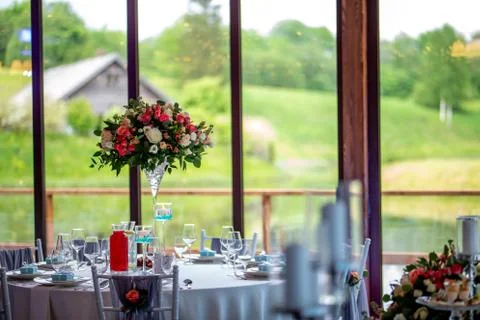 Wedding table decorated with flowers and dishes Stock Photos