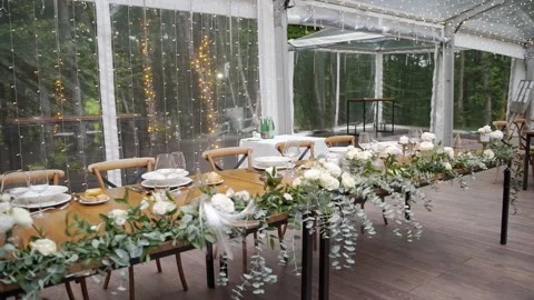 Wedding table decorated with flowers under a transparent tent Stock Footage 239735245