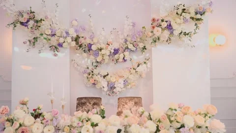 A wedding table decorated with flowers at which the newlyweds are sitting Video stock 328314435