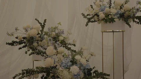 A wedding table decorated with flowers at which the newlyweds are sitting Stock Footage 329093107