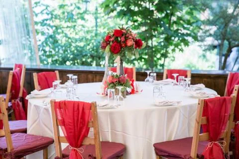 Wedding table decorated with red coloured chairs Stock Photos