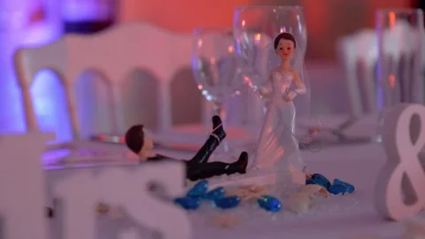 Wedding table decoration of bride and groom figurines with wine glasses Stock Footage 290766556