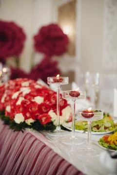 Wedding table decorations flowers, red candles decoration in glases Stock Photos