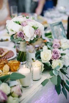 Wedding table decorations flowers, white candles decoration in glases Stock Photos