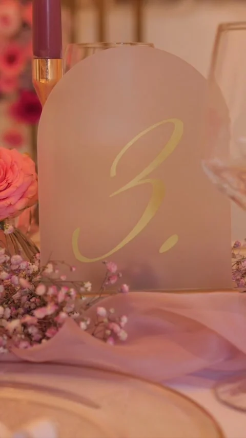Wedding table elegant number sign with pink flowers, romantic dinner setting Stock Footage 333052746