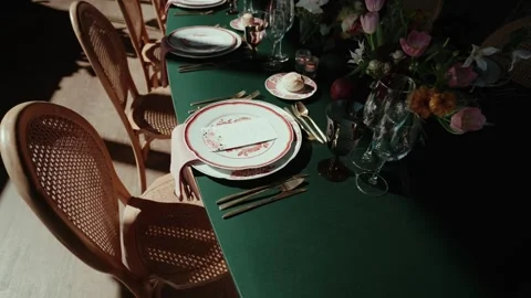 Wedding table place setting with plates cutlery glasses and flowers Stock Footage 332820063